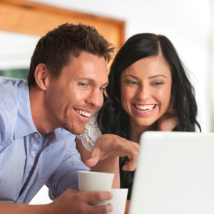 Couple looking at laptop computer CANVA
